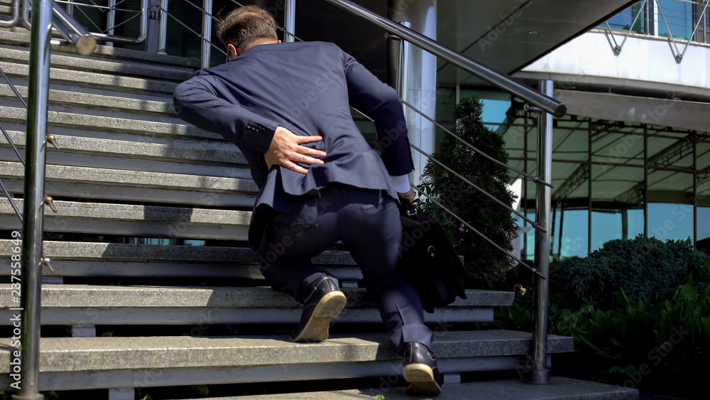 Office manager suffering back pain, spinal disorder, compressed nerve roots Office manager suffering back pain, spinal disorder, compressed nerve roots