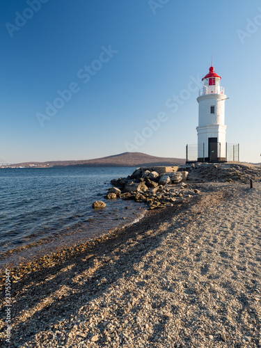 Tokarevsky lighthouse and people in the background of the Russian island of the Far Eastern city of Vladivostok. December, 2018