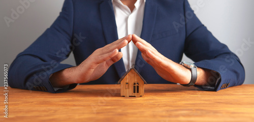 businessman house on wooden background