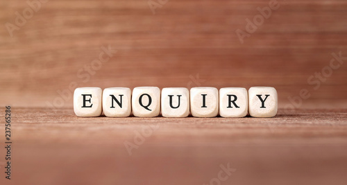 Word ENQUIRY made with wood building blocks
