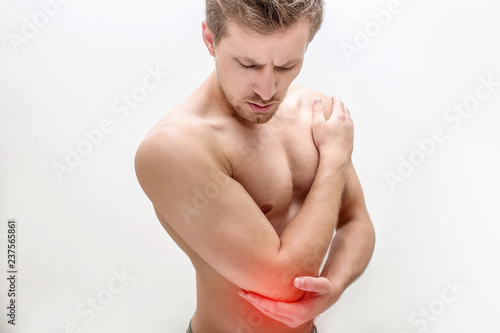Picture of red spot concentrated on man's elbow. He hold hand there and look down. Isolated on white background.