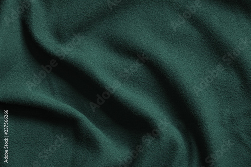 Texture of dark green fleece, soft fabric