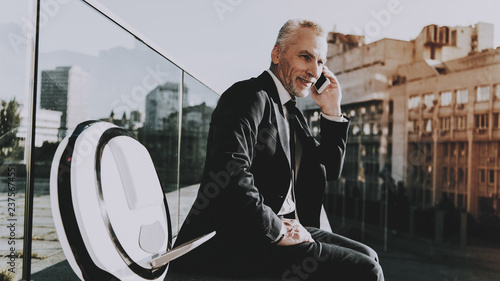 Businessman is Talking on Mobile Phone photo