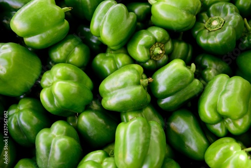 Indian Green Bell Peppers, view above several freshly harvested raw bell peppers, farmers market in Rajasthan, India photo