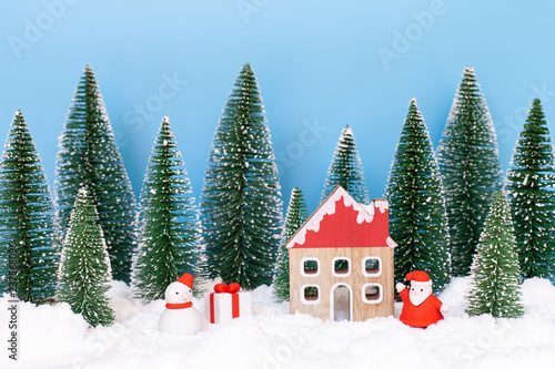 Landscape forest with christmas trees and house on the snow in winter. Concept of christmas holiday celebration and new year