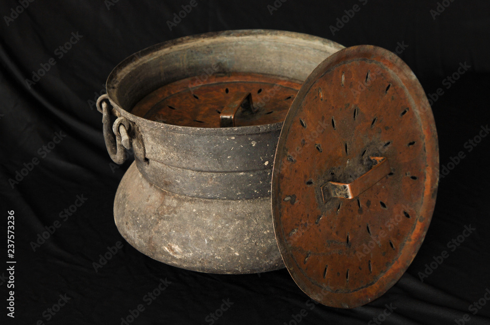 ancient metal bowl on dark background. antique bronze tableware