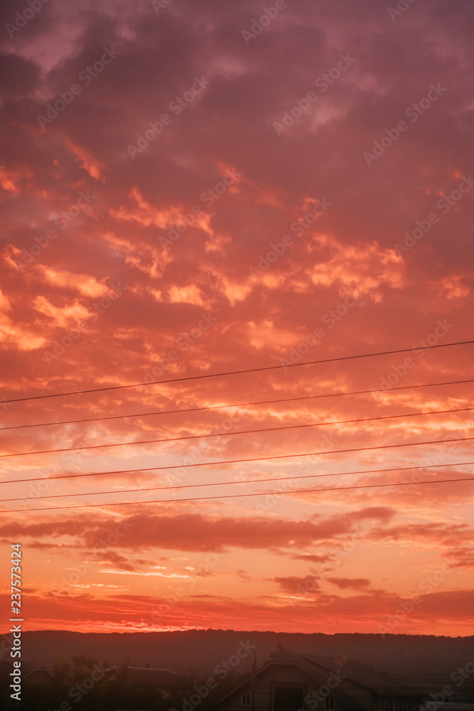Beautiful nature sky background with dramatic living coral clouds on sunrise.