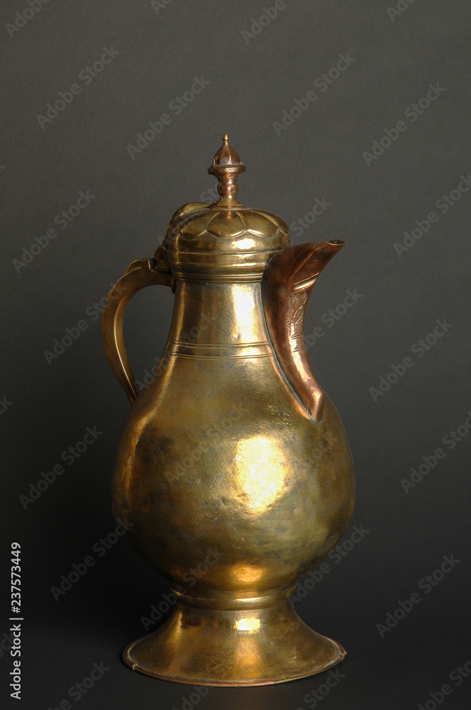 ancient oriental metal teapot on dark background. antique bronze tableware ancient oriental metal teapot on dark background. antique bronze tableware