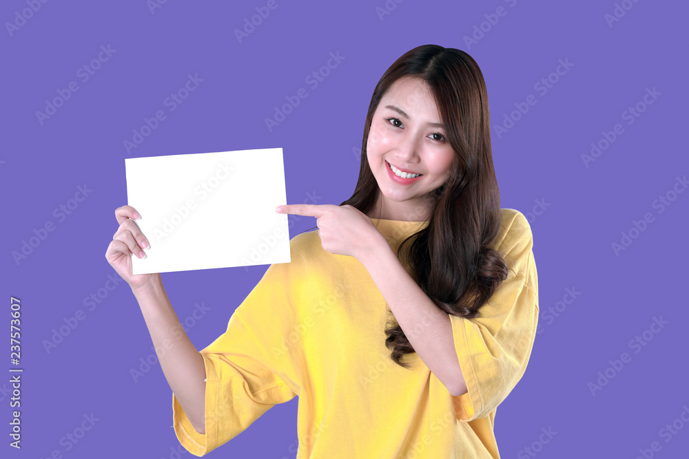 Young student woman show a blank resume, yellow t-shirt clothing, purple background Young student woman show a blank resume, yellow t-shirt clothing, purple background