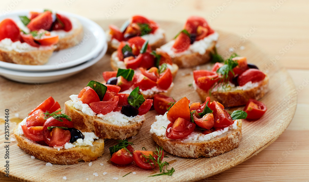 tomato and cheese bruschetta wood dish on table