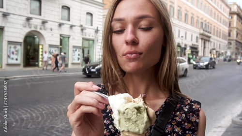 Ice cream in Italy. Tourist girl eats ice cream in Italy. Rome.