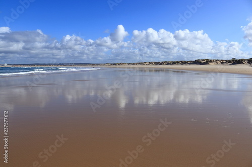 beach with cloudy sky reflected in the sand  Peniche