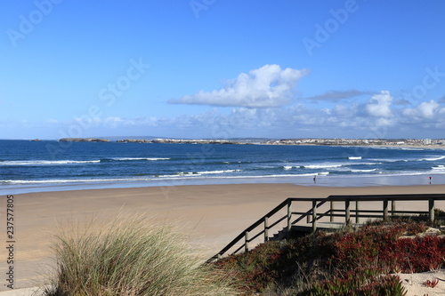 stairs to beach with blue sea in the background