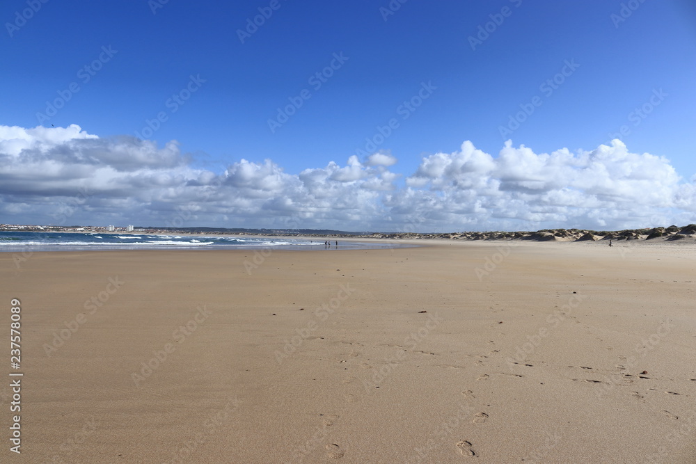 sand sea with people in background and sky with white clouds, Gamboa Beach