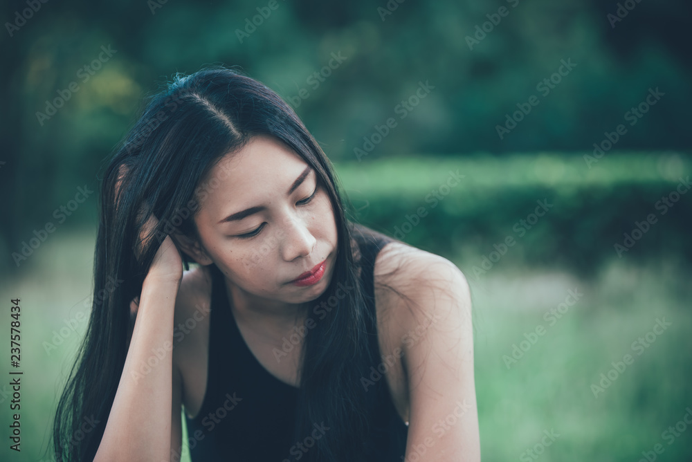 Beautiful thai woman very sad from unrequited love,rethink,think over,vintage style,dark tone,broken heart,asian girl
