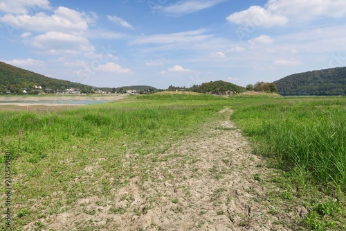 Trampelpfad über den Grund einer ausgetrocknete Bucht des Edersees im Sommer bei Bringhausen in Nordhessen photo