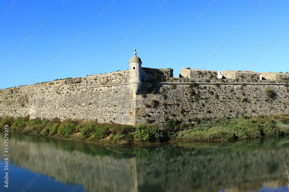 ancient fortification in the city of Peniche lined with water and its reflections