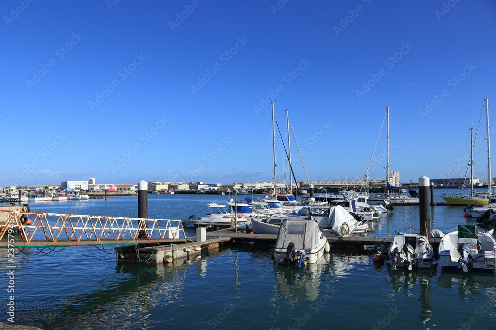 boats in the blue water of Peniche marina in Portugal