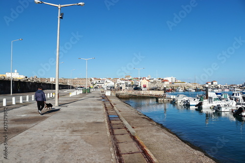 man walking the dog in the marina of Peniche © Artur Gomes