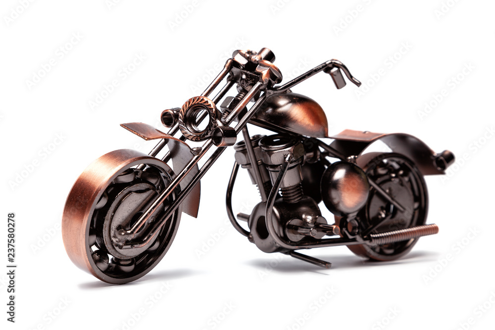 Handmade model of custom motorcycle bike. Copper scale model of chopper. Side view. Isolated on white. Handmade model of custom motorcycle bike. Copper scale model of chopper. Side view. Isolated on white.