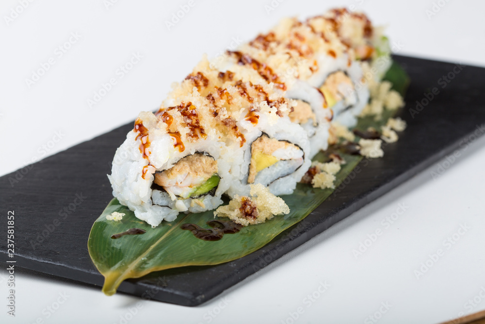 Fresh uramaki sushi rolls served on leaf Fresh uramaki sushi rolls served on leaf