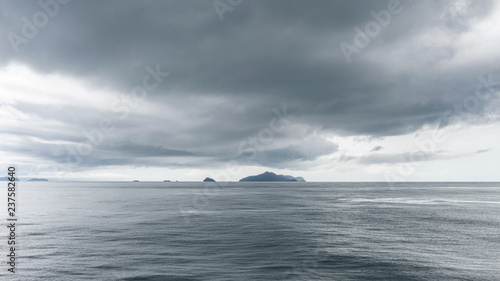 Sea and island with dark rain clouds in rainy season