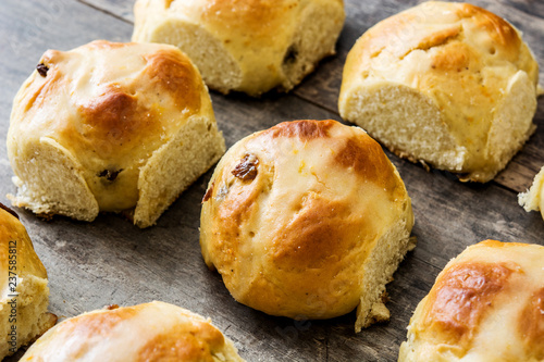 Traditional Easter hot cross buns on wooden table. 