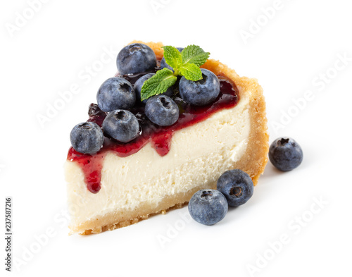 Piece of cheesecake with blueberries and mint isolated on white