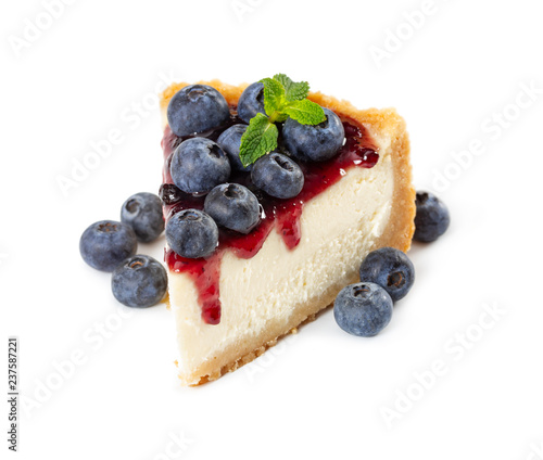Piece of cheesecake with blueberries and mint