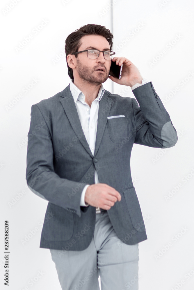 serious businessman talking on a smartphone serious businessman talking on a smartphone