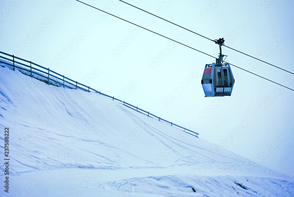 Cable car in a ski resort going up. Winter season