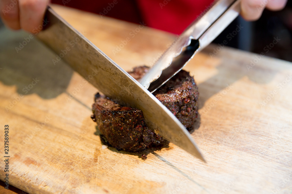 Chopping the beefsteak on Wooden Cutting Board Chopping the beefsteak on Wooden Cutting Board