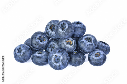 Blueberries with green leaves closeup, isolated on white background