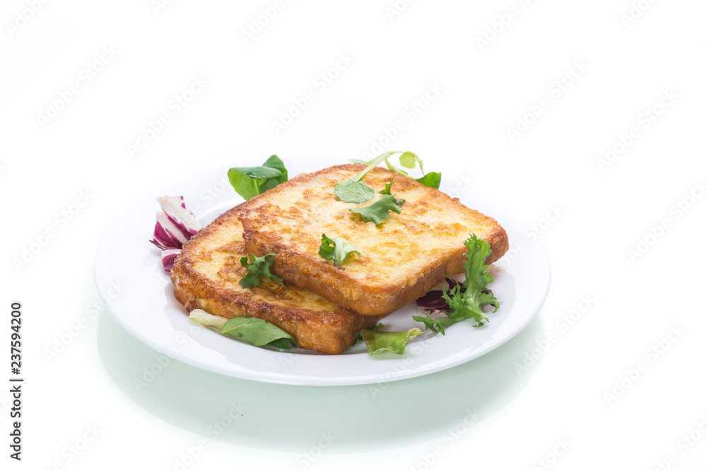 fried croutons in eggs with greens in a plate