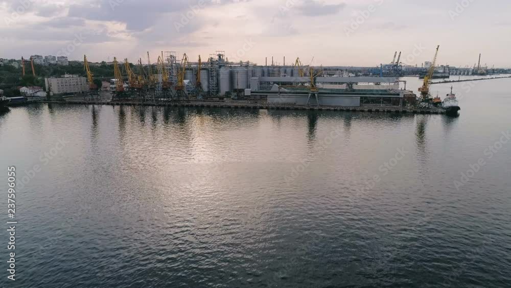 Odessa industrial seaport with cranes and huge metallic cisterns in summer Odessa industrial seaport with cranes and huge metallic cisterns in summer