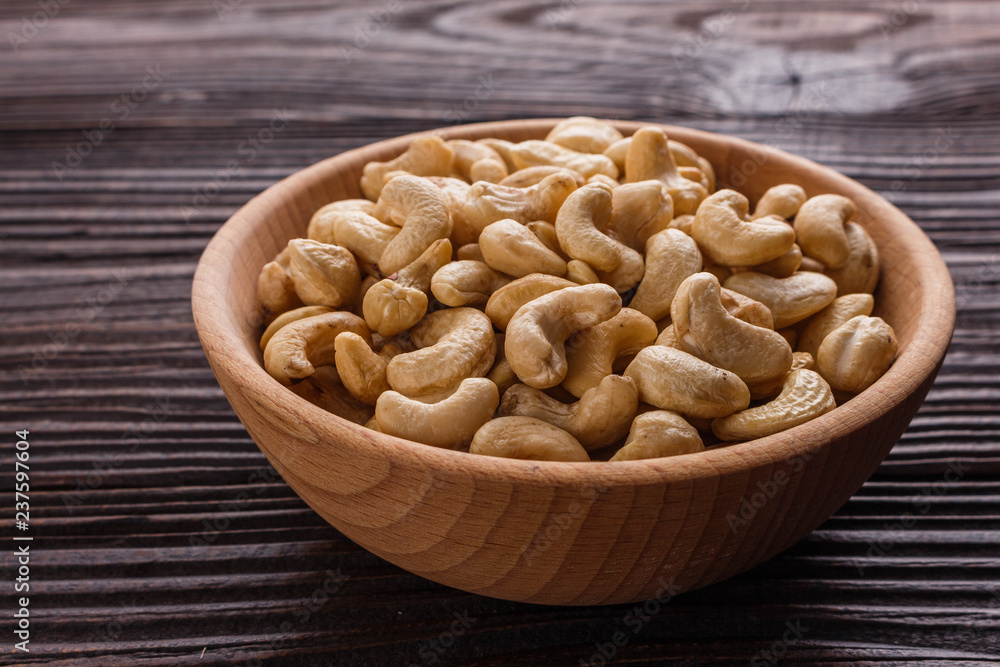 cashew nuts on a rustic wooden background cashew nuts on a rustic wooden background