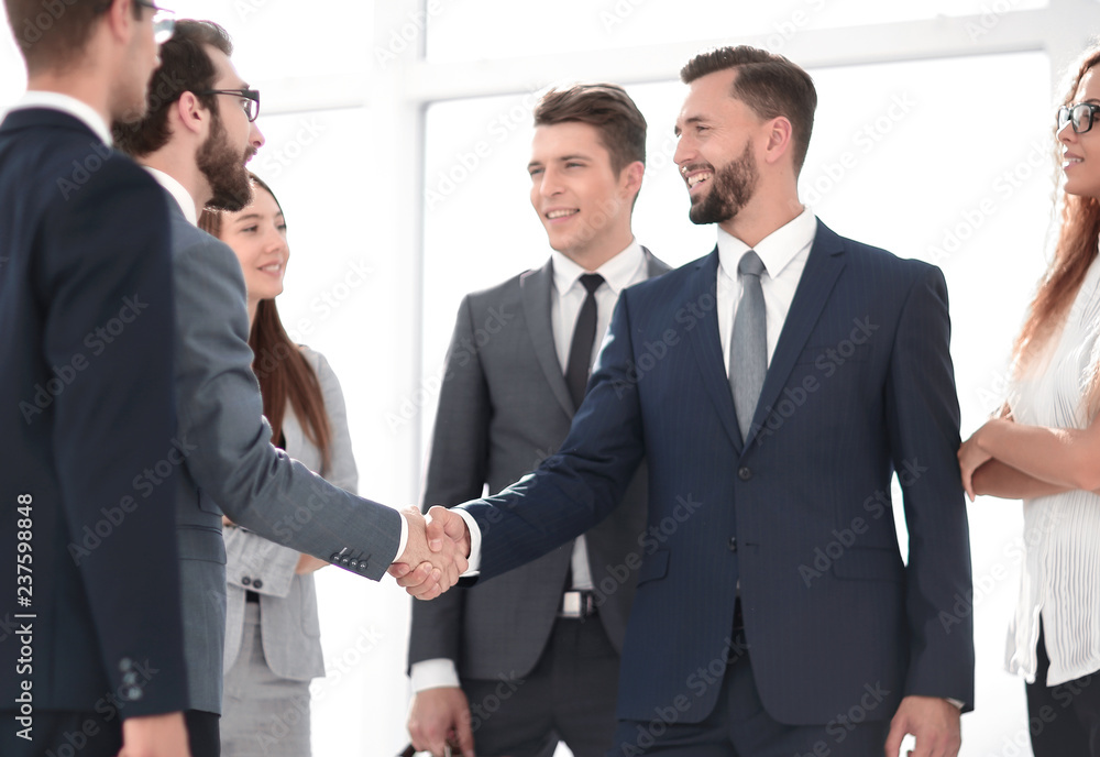 Business partners shaking hands as a symbol of unity Business partners shaking hands as a symbol of unity
