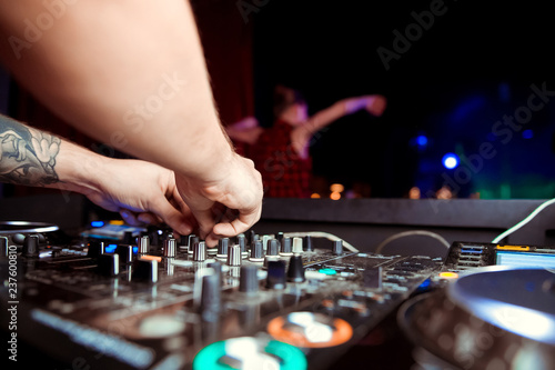 DJ sound equipment at nightclubs and music festivals, EDM, future house music and so on. Parties concept, sound technique. DJ playing on the best, famous CD players.