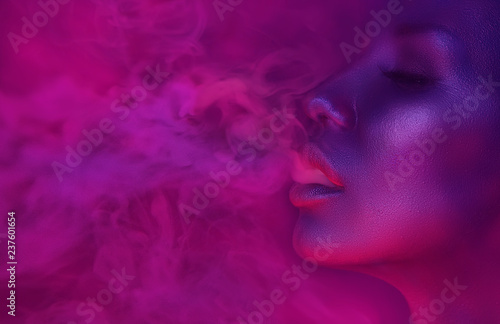 Vape Party, Nightlife. Beautiful Sexy Woman smoking photo