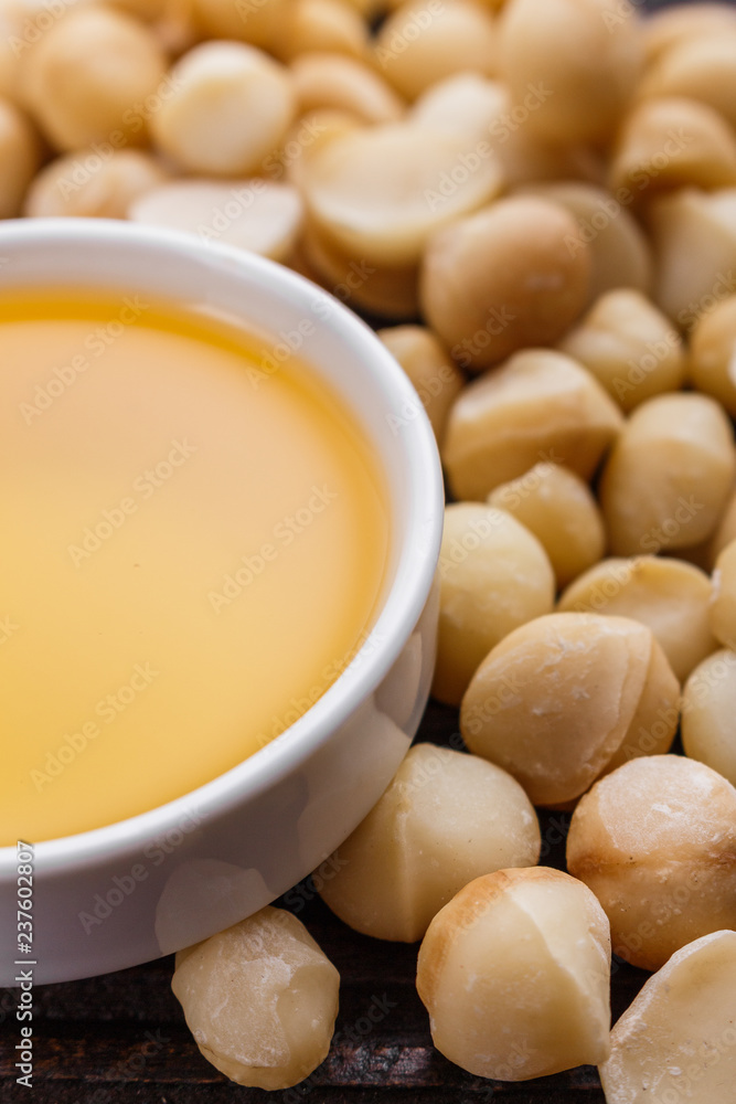 delicious macadamia nuts on a wooden rustic background delicious macadamia nuts on a wooden rustic background