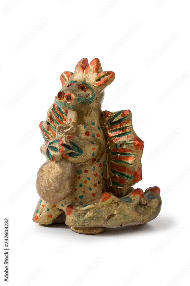 Golden dragon holding a bag with gifts. Toy from the baked clay (Filimonovskaya toy). Folk art.