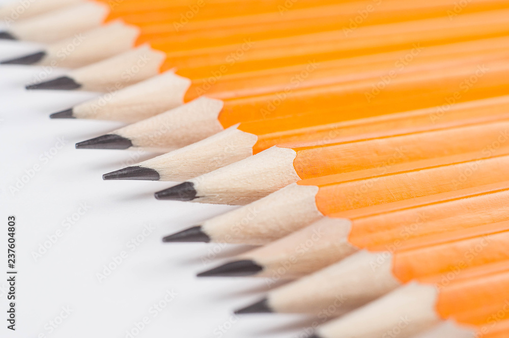 Fototapeta premium orange pencils with graphite rods on a white background