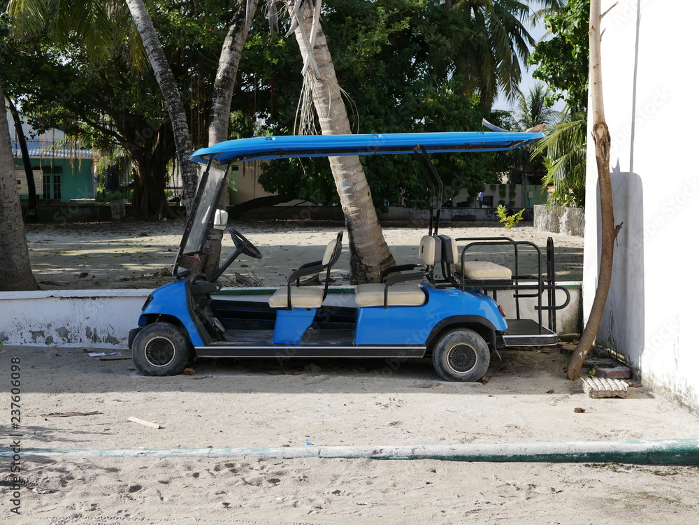 blue Golf cart on a sandy beach in Maldives