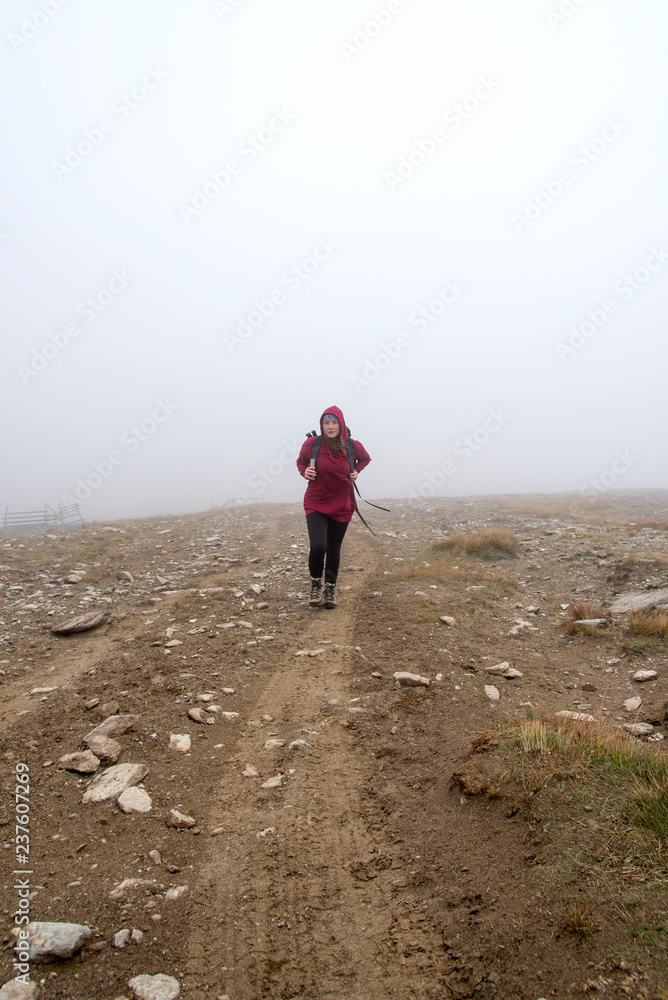Fototapeta premium Woman in the fog on the mountain