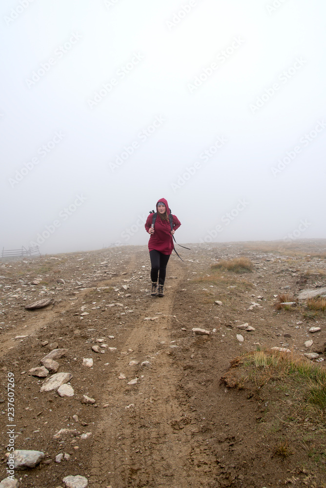 Woman in the fog on the mountain