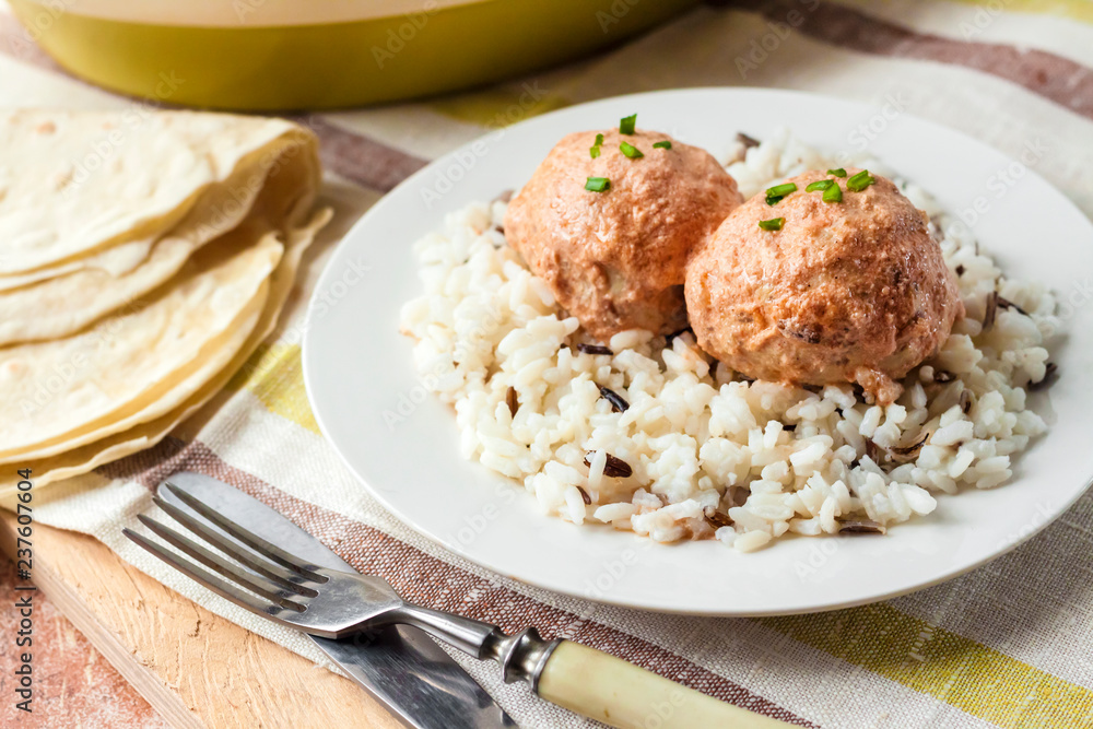 Chicken meatballs in creamy tomato sauce with rice Chicken meatballs in creamy tomato sauce with rice