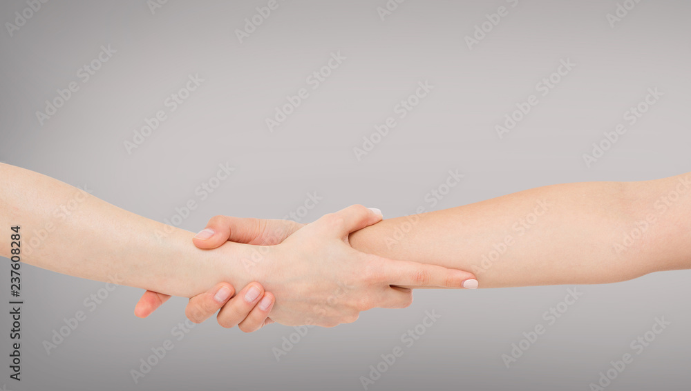 Rescuing and helping by holding or gripping the forearm.Hand and arm pulling up. The Concept of help, love, friendship Rescuing and helping by holding or gripping the forearm.Hand and arm pulling up. The Concept of help, love, friendship
