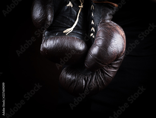 pair of very old brown boxing gloves hanging
