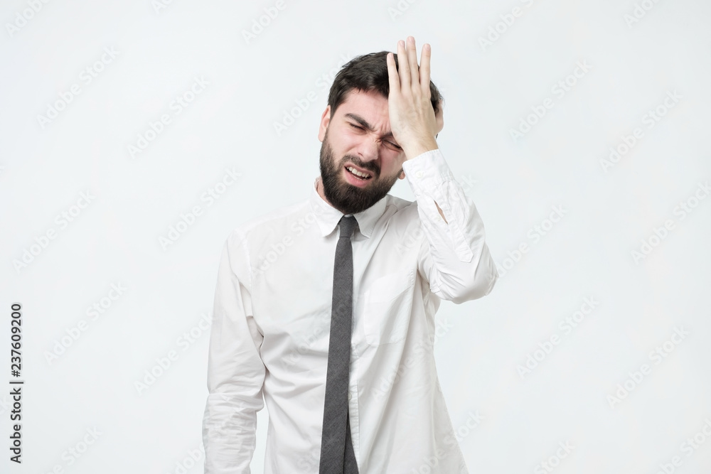 Hispanic man hold his head in hand forgotten something. Where I put my car keys concept. Hispanic man hold his head in hand forgotten something. Where I put my car keys concept.