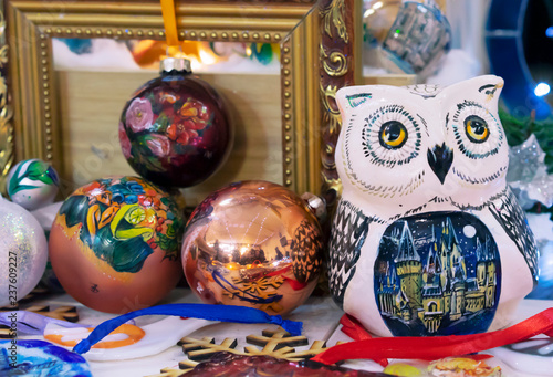 Ceramic statuette of an owl next to the Christmas decorations. © Valemaxxx